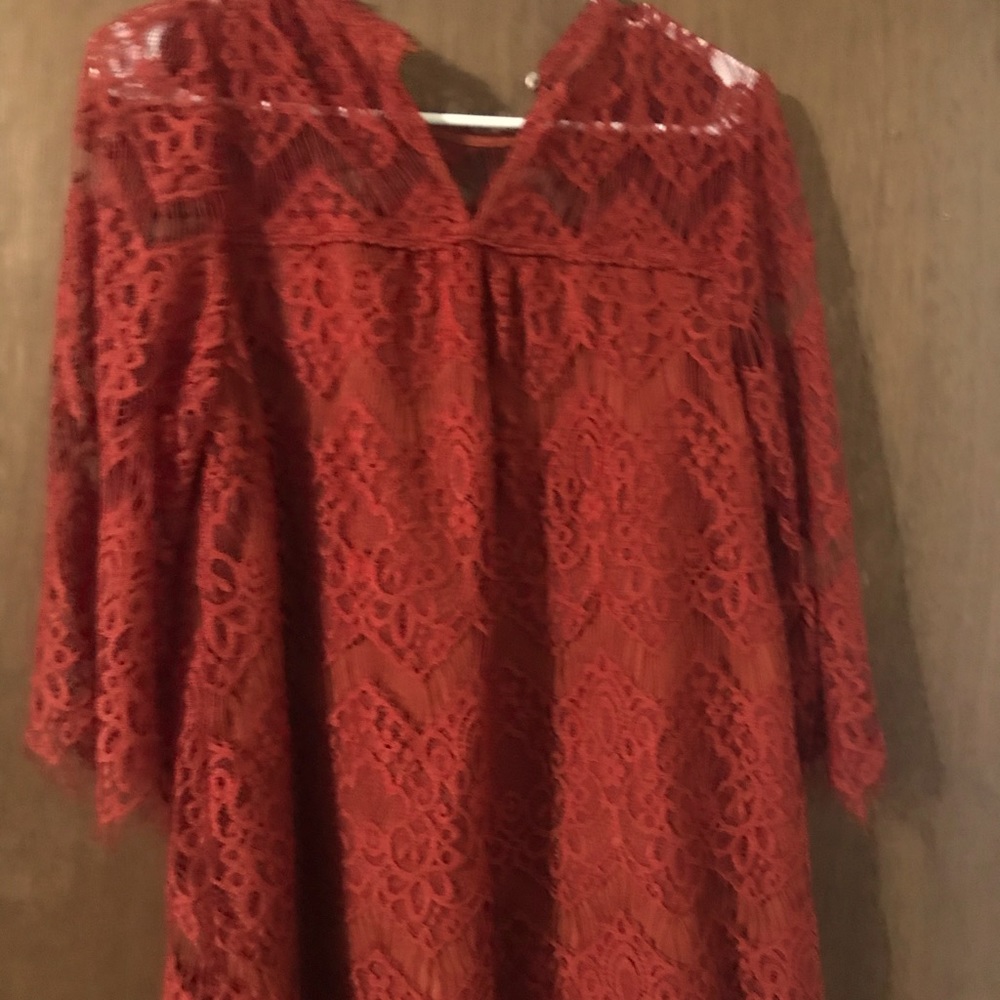 Rust colored lacey shirt.